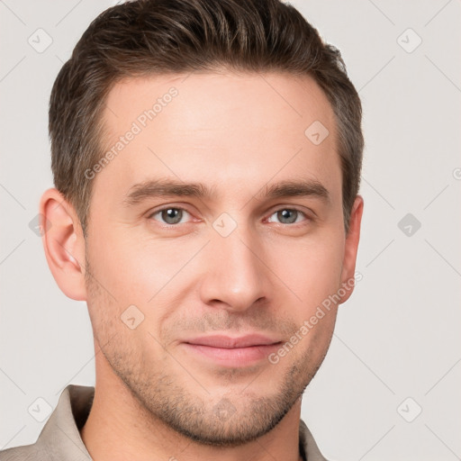 Joyful white young-adult male with short  brown hair and grey eyes