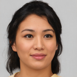 Joyful asian young-adult female with medium  brown hair and brown eyes