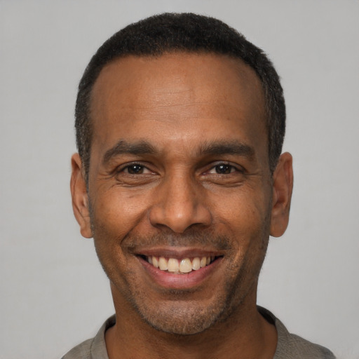 Joyful latino adult male with short  black hair and brown eyes