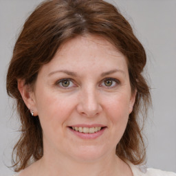 Joyful white adult female with medium  brown hair and grey eyes