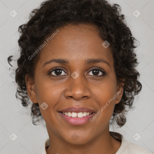 Joyful black adult female with medium  brown hair and brown eyes