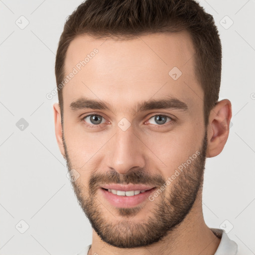 Joyful white young-adult male with short  brown hair and brown eyes