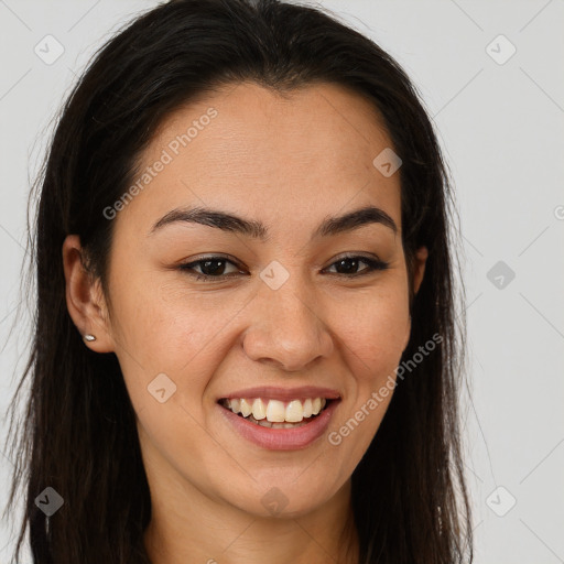 Joyful latino young-adult female with long  brown hair and brown eyes