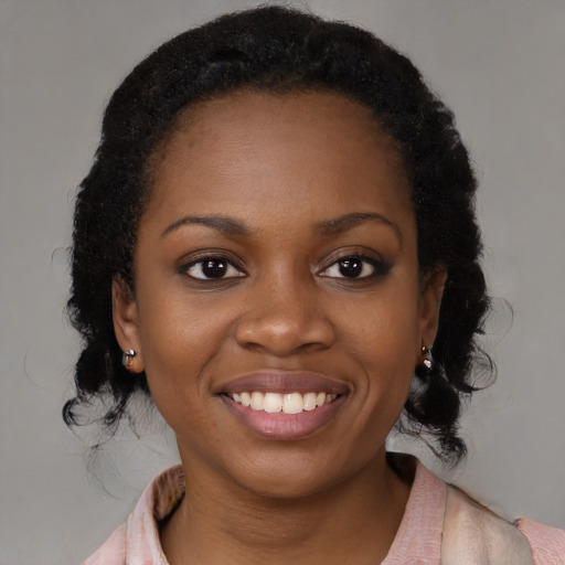 Joyful black young-adult female with medium  brown hair and brown eyes