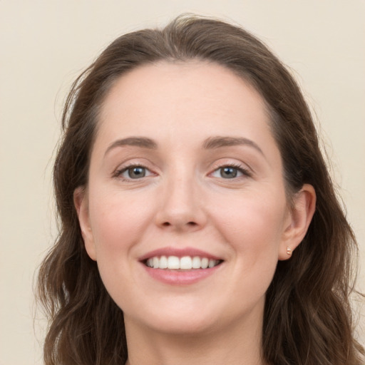 Joyful white young-adult female with long  brown hair and grey eyes