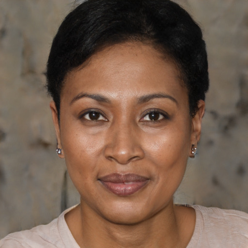 Joyful black adult female with short  brown hair and brown eyes