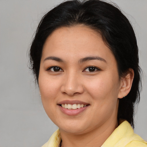 Joyful white young-adult female with medium  brown hair and brown eyes