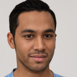 Joyful latino young-adult male with short  brown hair and brown eyes