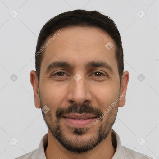 Joyful white young-adult male with short  black hair and brown eyes