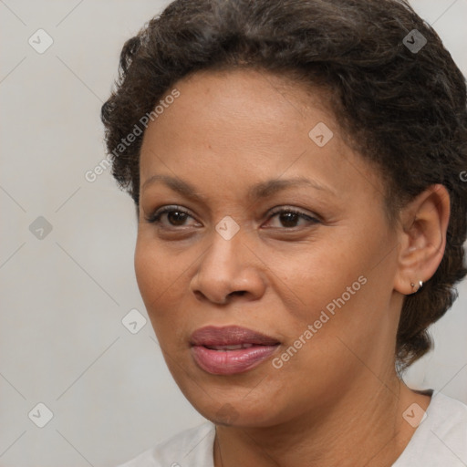 Joyful black adult female with medium  brown hair and brown eyes