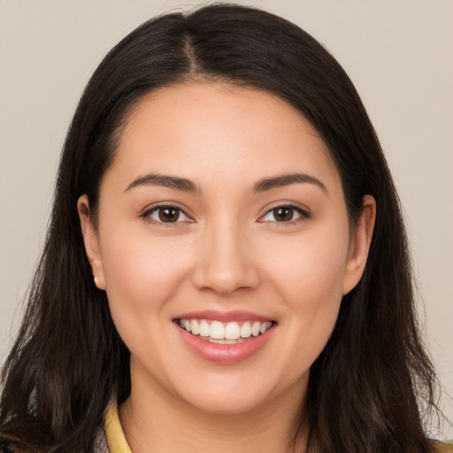 Joyful white young-adult female with long  brown hair and brown eyes