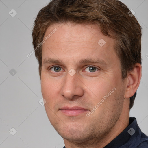 Joyful white adult male with short  brown hair and grey eyes