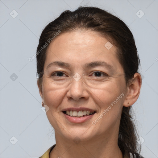 Joyful white adult female with medium  brown hair and brown eyes