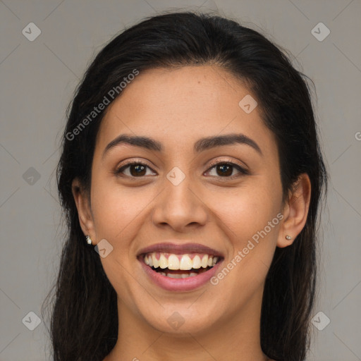 Joyful latino young-adult female with long  brown hair and brown eyes