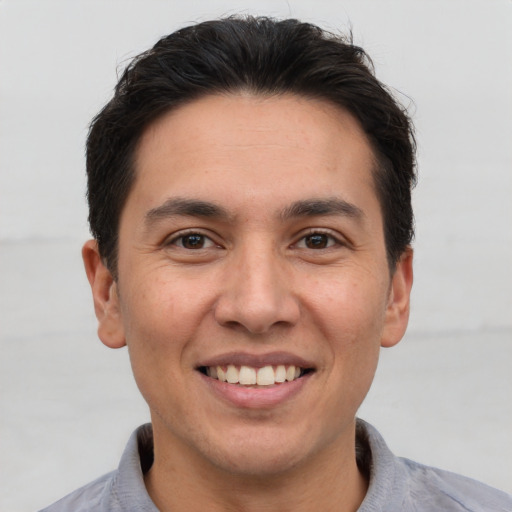 Joyful white young-adult male with short  brown hair and brown eyes