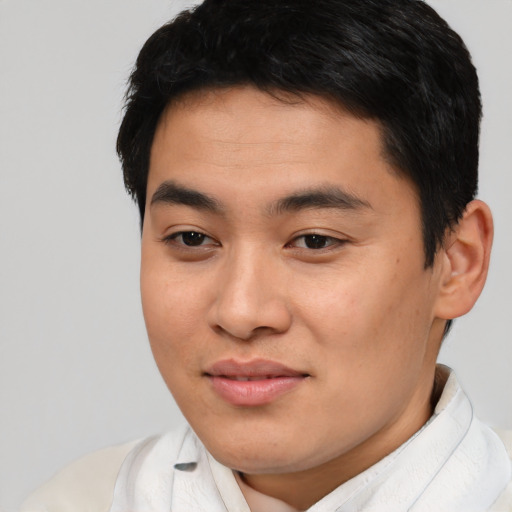 Joyful asian young-adult male with short  black hair and brown eyes