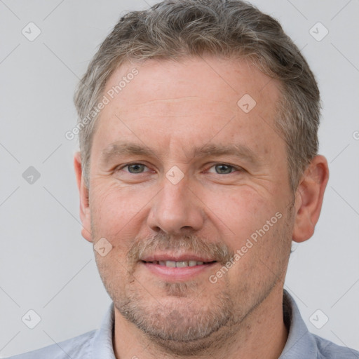 Joyful white adult male with short  brown hair and grey eyes