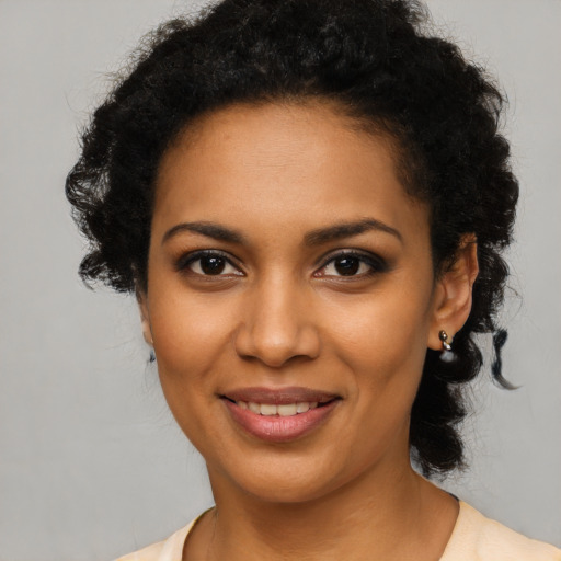 Joyful black young-adult female with short  brown hair and brown eyes