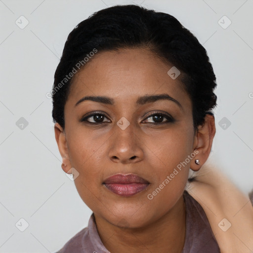 Joyful black young-adult female with short  black hair and brown eyes