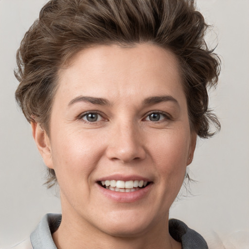 Joyful white young-adult female with short  brown hair and grey eyes