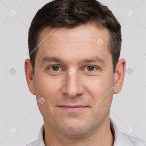 Joyful white adult male with short  brown hair and brown eyes