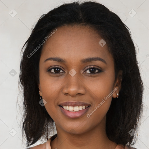 Joyful black young-adult female with long  brown hair and brown eyes