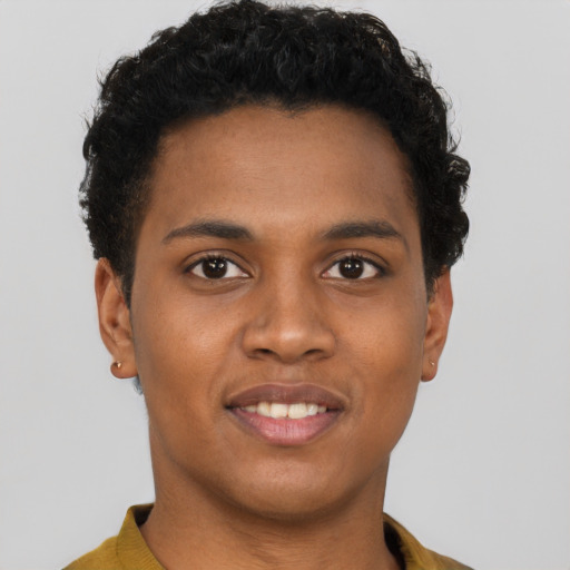 Joyful black young-adult male with short  brown hair and brown eyes