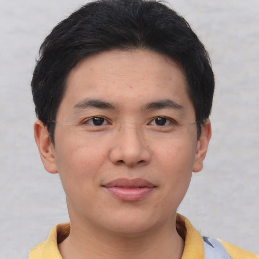 Joyful asian young-adult male with short  brown hair and brown eyes