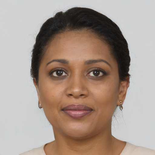 Joyful black young-adult female with short  brown hair and brown eyes