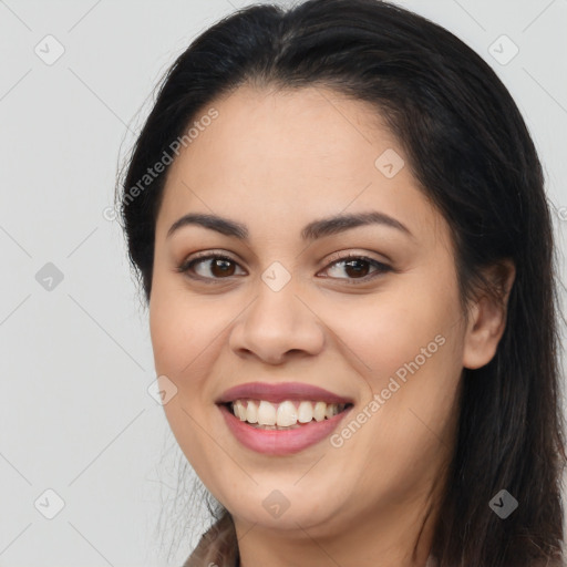 Joyful latino young-adult female with long  brown hair and brown eyes