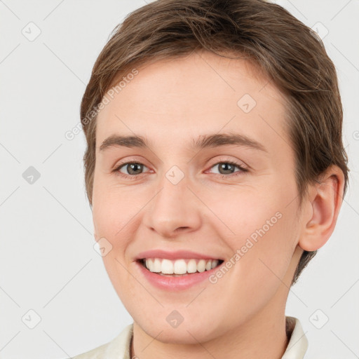 Joyful white young-adult female with short  brown hair and grey eyes