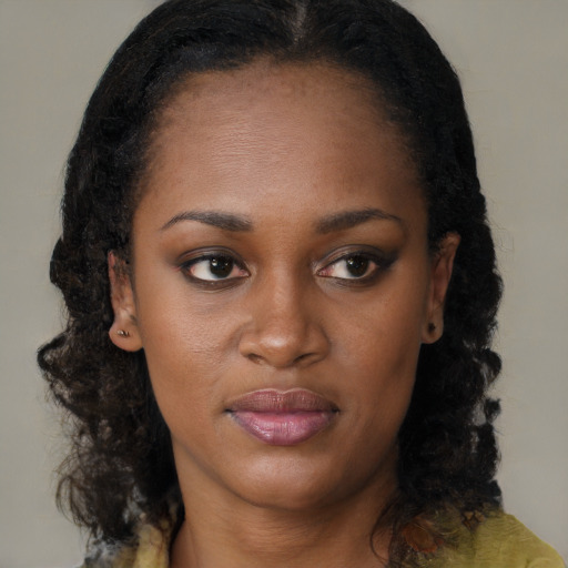 Joyful black young-adult female with medium  brown hair and brown eyes