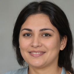 Joyful white adult female with medium  brown hair and brown eyes