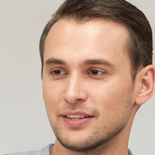 Joyful white young-adult male with short  brown hair and brown eyes