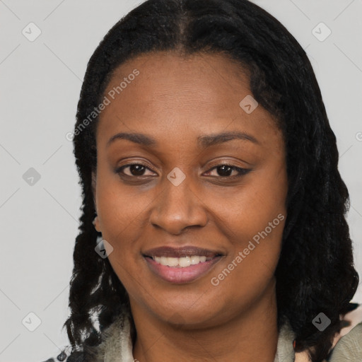 Joyful black young-adult female with long  black hair and brown eyes