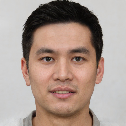Joyful white young-adult male with short  black hair and brown eyes