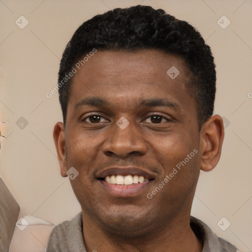 Joyful black young-adult male with short  black hair and brown eyes