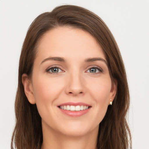 Joyful white young-adult female with long  brown hair and grey eyes