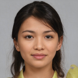 Joyful latino young-adult female with medium  brown hair and brown eyes