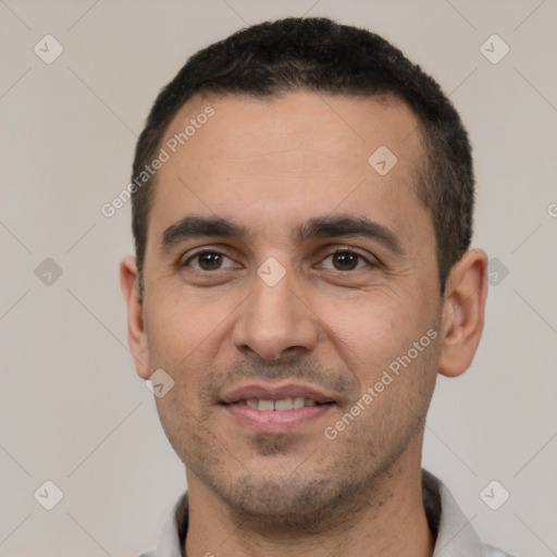 Joyful white young-adult male with short  black hair and brown eyes