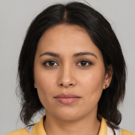 Joyful latino young-adult female with medium  brown hair and brown eyes