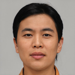 Joyful asian young-adult male with short  black hair and brown eyes