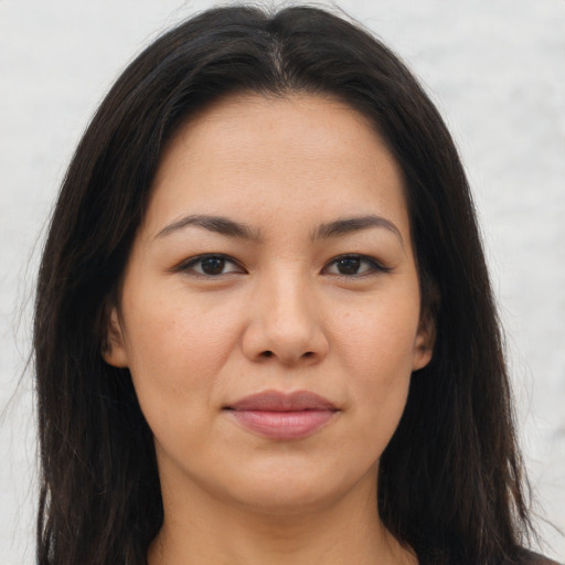 Joyful asian young-adult female with long  brown hair and brown eyes