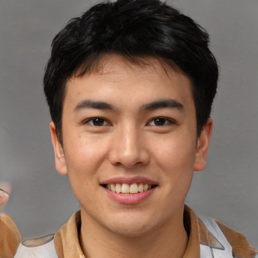 Joyful asian young-adult male with short  brown hair and brown eyes