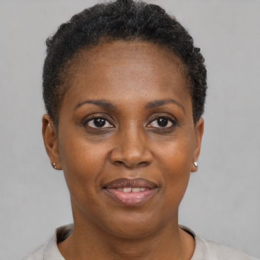 Joyful black adult female with short  brown hair and brown eyes