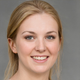 Joyful white young-adult female with medium  brown hair and blue eyes