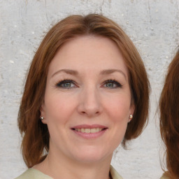 Joyful white young-adult female with medium  brown hair and blue eyes