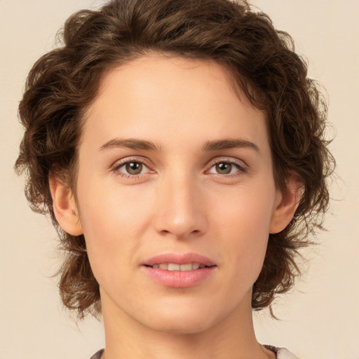 Joyful white young-adult female with medium  brown hair and green eyes