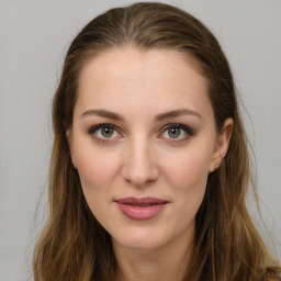 Joyful white young-adult female with long  brown hair and green eyes