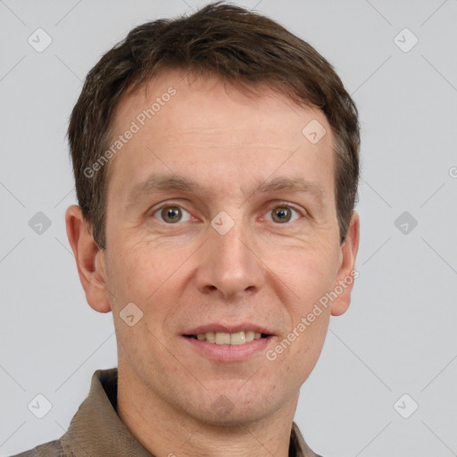 Joyful white adult male with short  brown hair and grey eyes